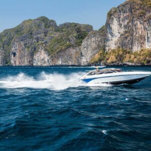 Speedboat in Phi Phi Islands with limestone cliffs in the background