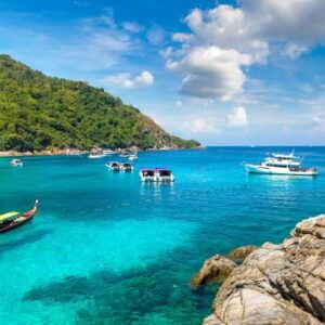 boats anchored in the shallow waters at koh rachai yai